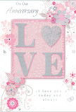 This anniversary card offers a quiet, heartfelt celebration of enduring love, as if designed for couples strolling through Egham's leafy streets or along the river at Runnymede. At its centre, the word LOVE appears in raised lettering, each character dusted with pale glitter that flickers softly between blush pink, creamy white, and delicate silver-grey. The uplifted texture invites a gentle touch, mirroring the tactile pleasure of handling freshly arranged stems and blossoms. The backdrop is a soft, pastel pink wash, subtly deepening at the edges to create depth without drama, like a calm sky at dusk. Around the central word, a constellation of stylised flowers, tendrils, and leaves gently curls and unwinds. The blossoms are illustrated in light blush, mauve, ivory, and faint silvery tones, giving the impression of a pastel bouquet loosely scattered around the card. Each petal and leaf is outlined in fine, sensitive strokes, with occasional shimmers of silver detailing that catch the light in a way reminiscent of dewdrops on morning flowers. Small, whimsical flourishes-petals in mid-air, graceful swirls, and shy butterfly shapes-add a sense of motion and playfulness, while still maintaining a refined mood. Near the top or lower part of the design, the words On Our Anniversary and I love you today and always are inscribed in an elegant, flowing script, harmonising with the curves of the florals. The result is a card that feels intimately personal and softly celebratory, an ideal partner to a delicate arrangement delivered across Egham, marking another year of shared stories and quiet, steadfast affection.